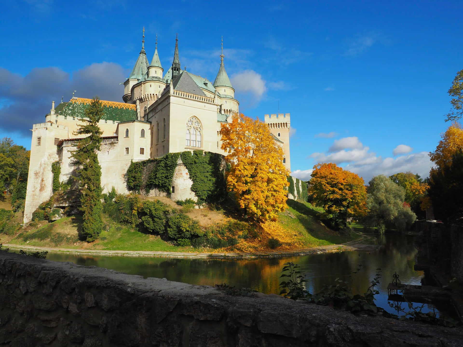 Bojnice Castle Surrounded Water And Grass Background