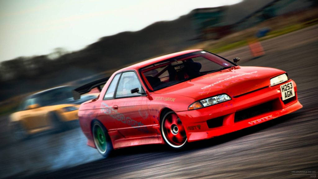 Bold Red Skyline Racing Car In Motion Background