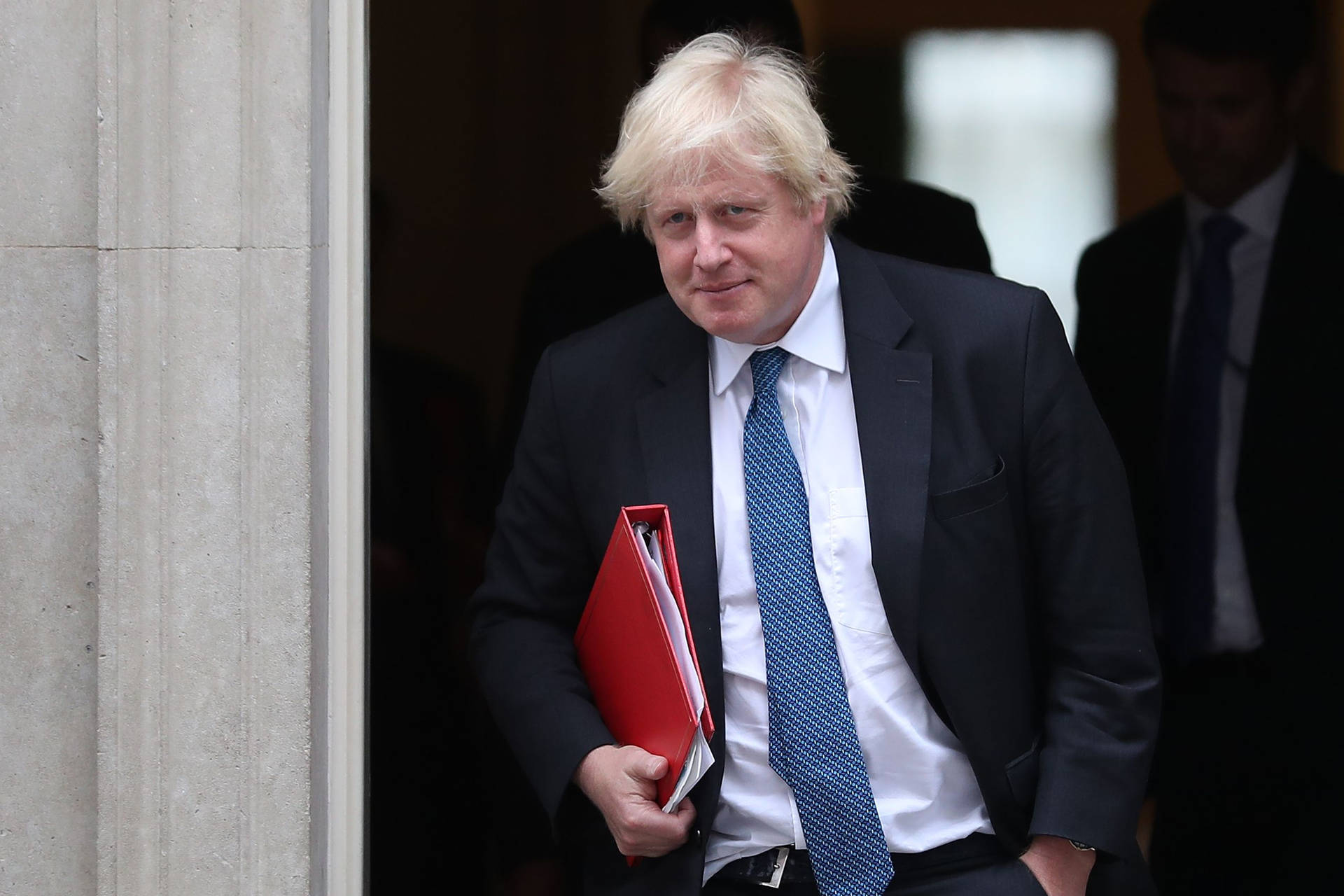 Boris Johnson Holding A Red Folder Background