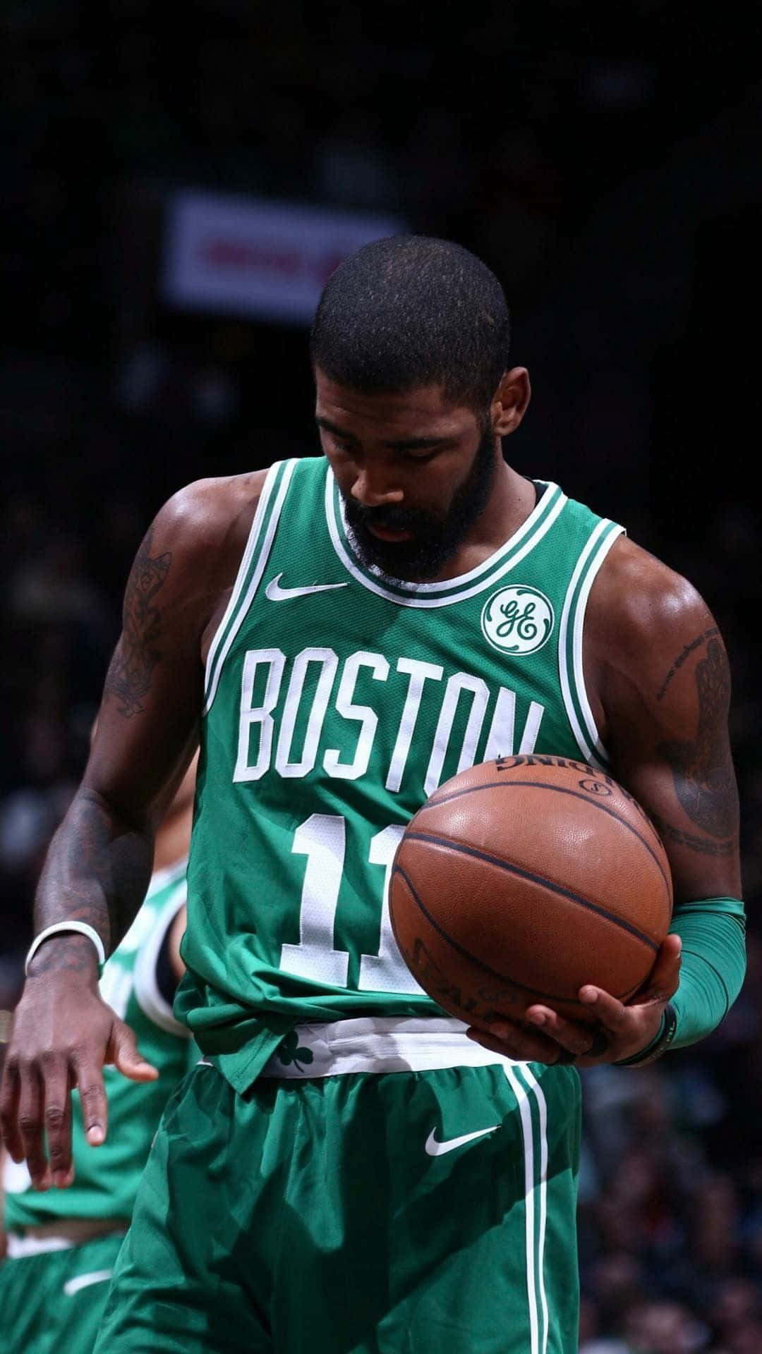 Boston Celtics Player Holding A Basketball Ball Background