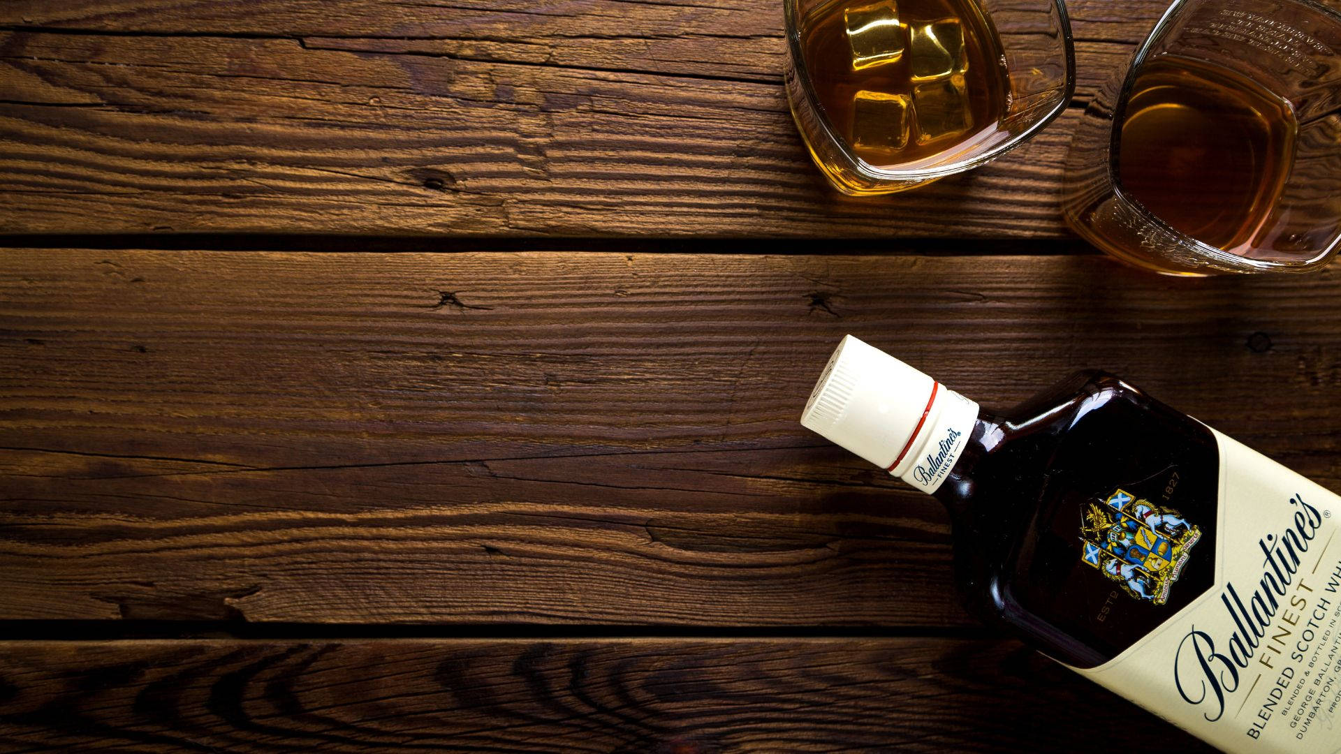 Bottle And Glasses Of Alcohol On Wooden Table Background