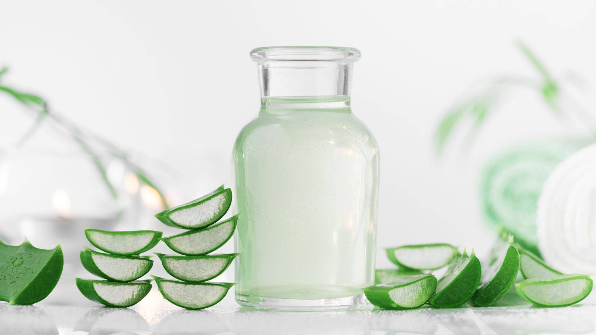 Bottle With Aloe Vera Slices Background