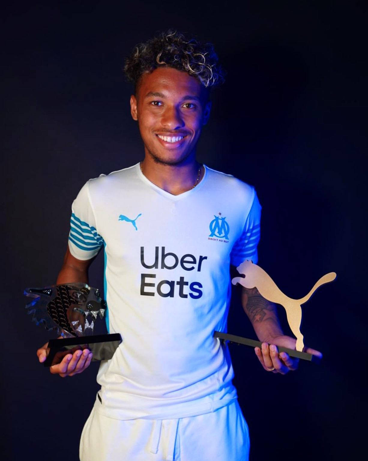 Boubacar Kamara Holding Two Trophies Background