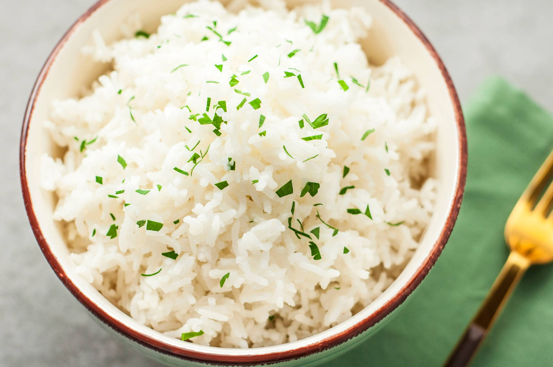 Bowl Of White Rice With An Herb Garnish Background