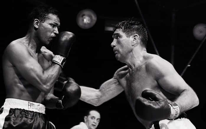 Boxer Joey Maxim Intensely Focused During A Match Background
