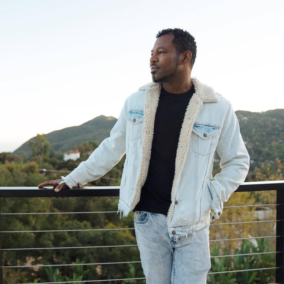 Boxing Legend Shane Mosley In Denim Attire Background