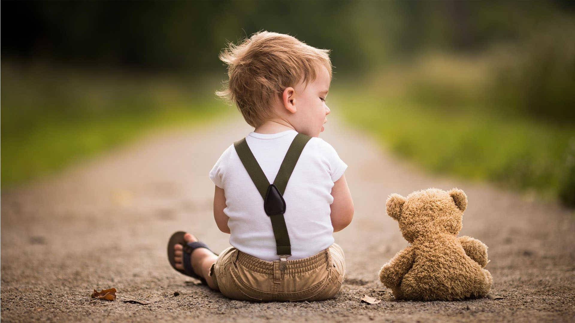 Boy Child With Teddy Bear On The Road