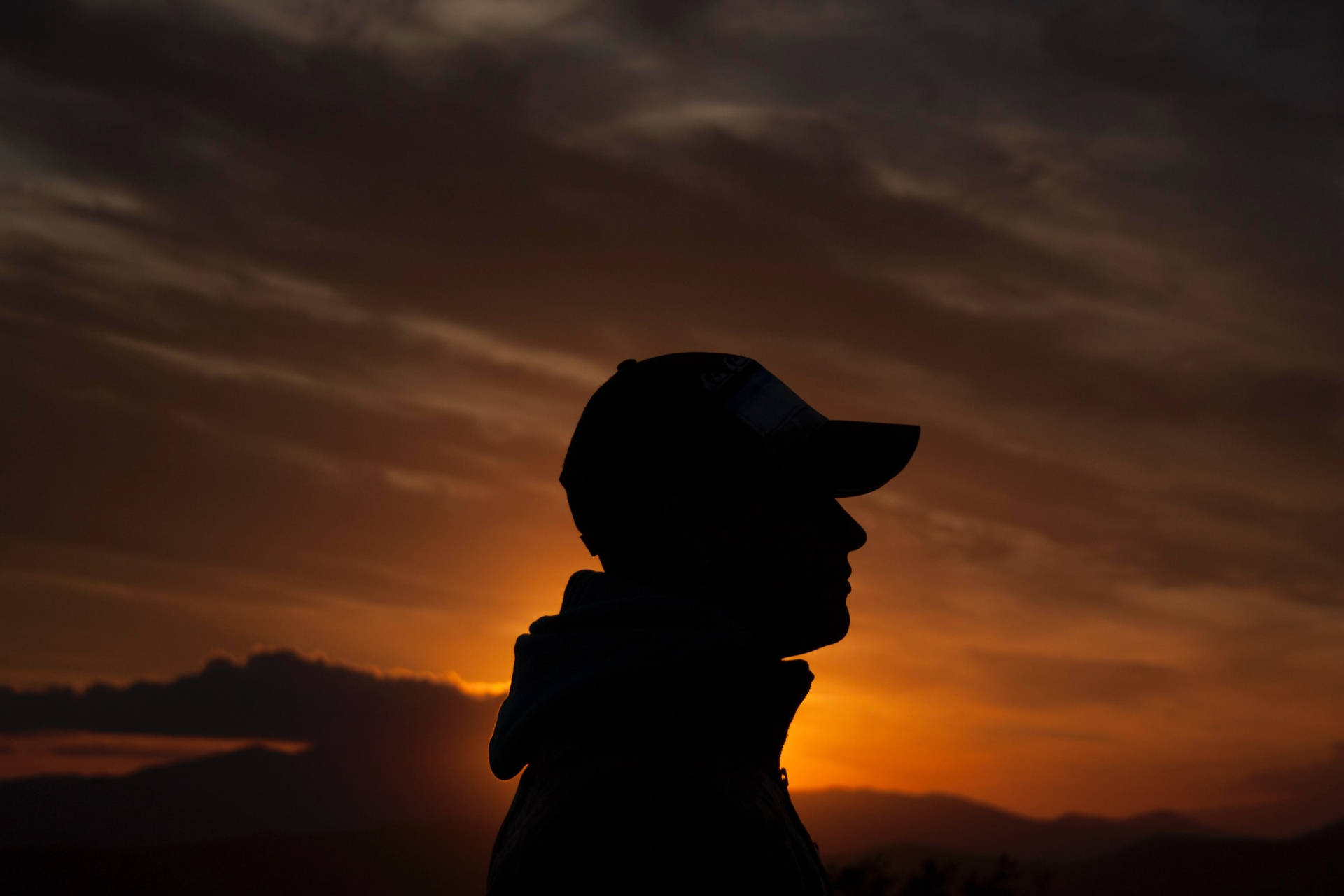 Boy In A Hoodie In A Golden Dusk Profile Background