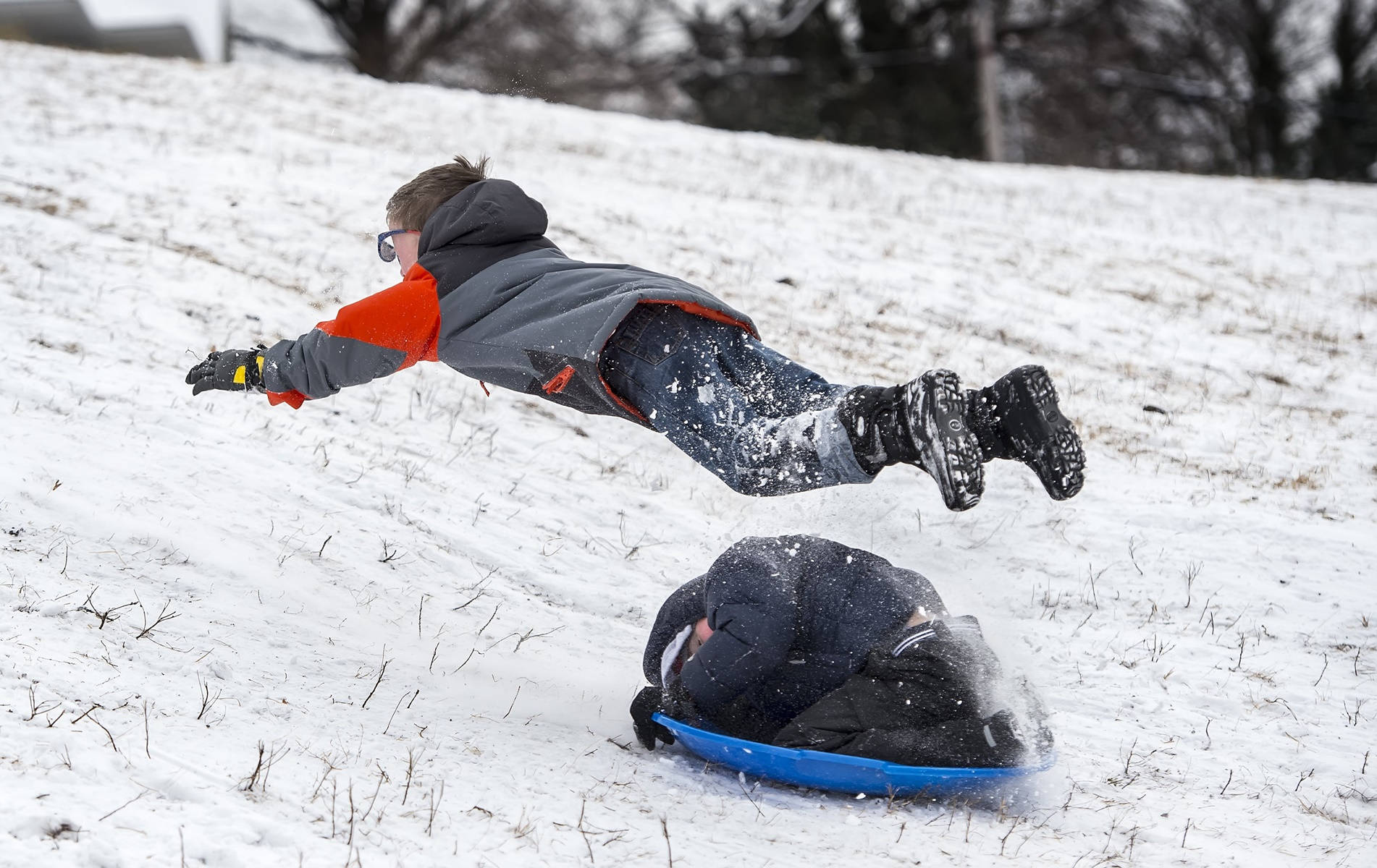 Boy Jump Over Sledding Background