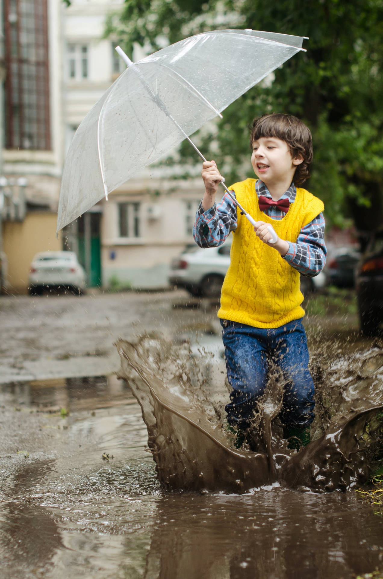 Boy Playing Outside While It's Raining Background