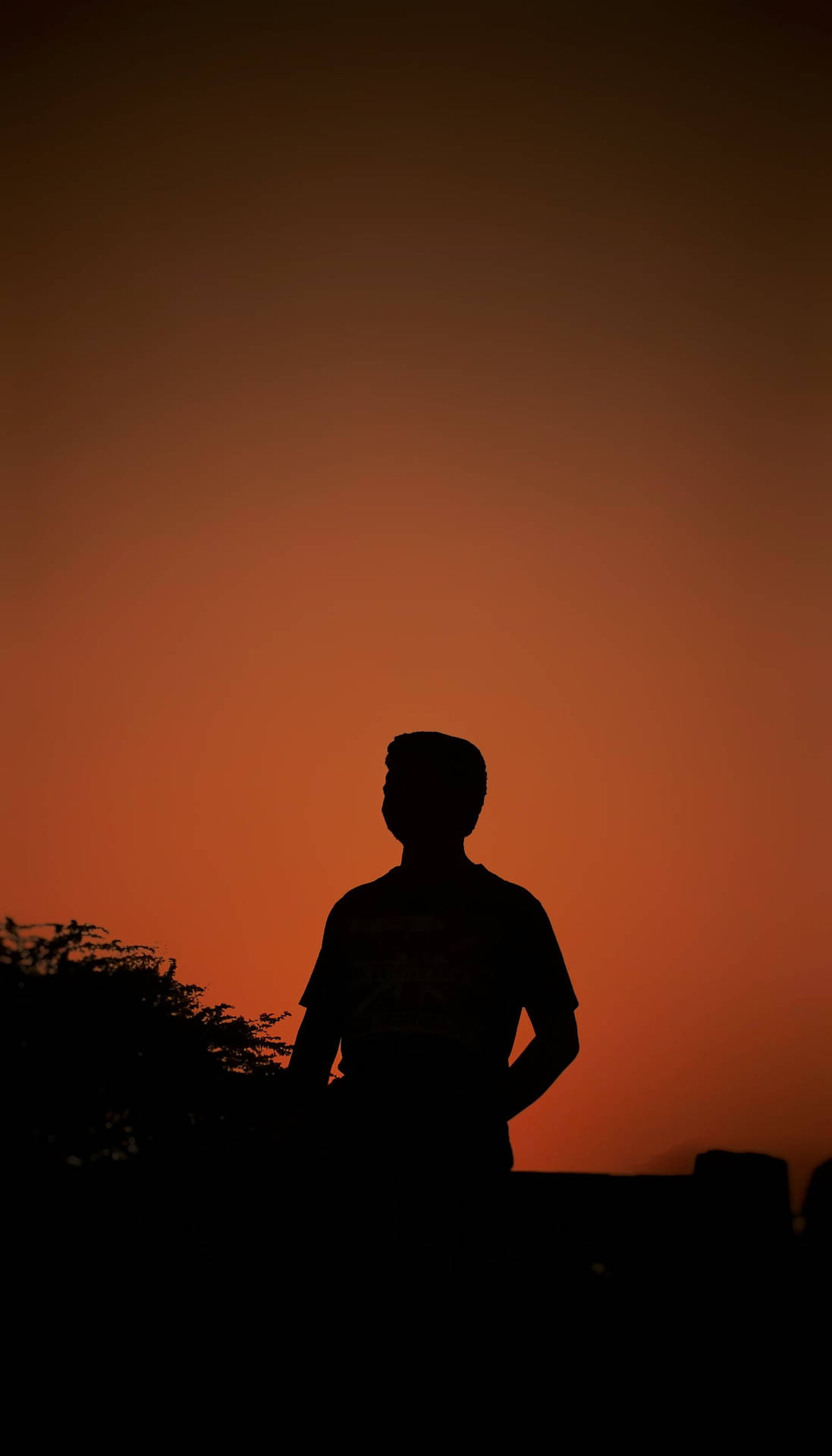 Boy Shadow On An Orange Sunset Sky Background