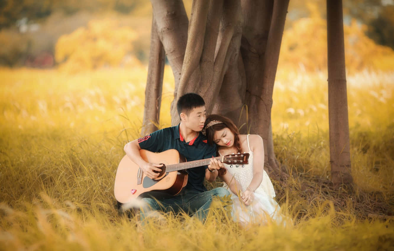 Boyfriend Playing Guitar For His Girlfriend Background