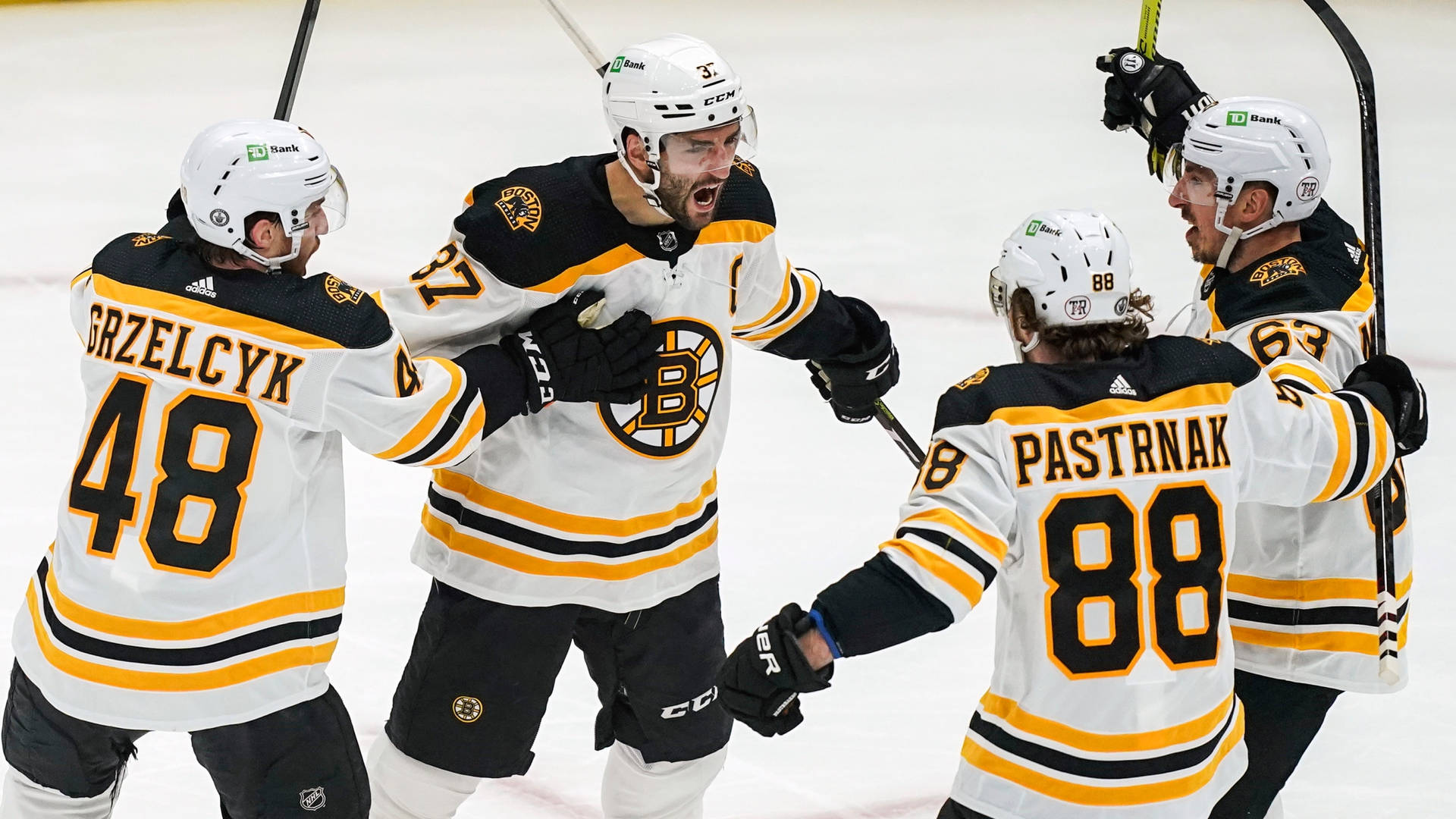 Brad Marchand Celebrating With Teammates Background