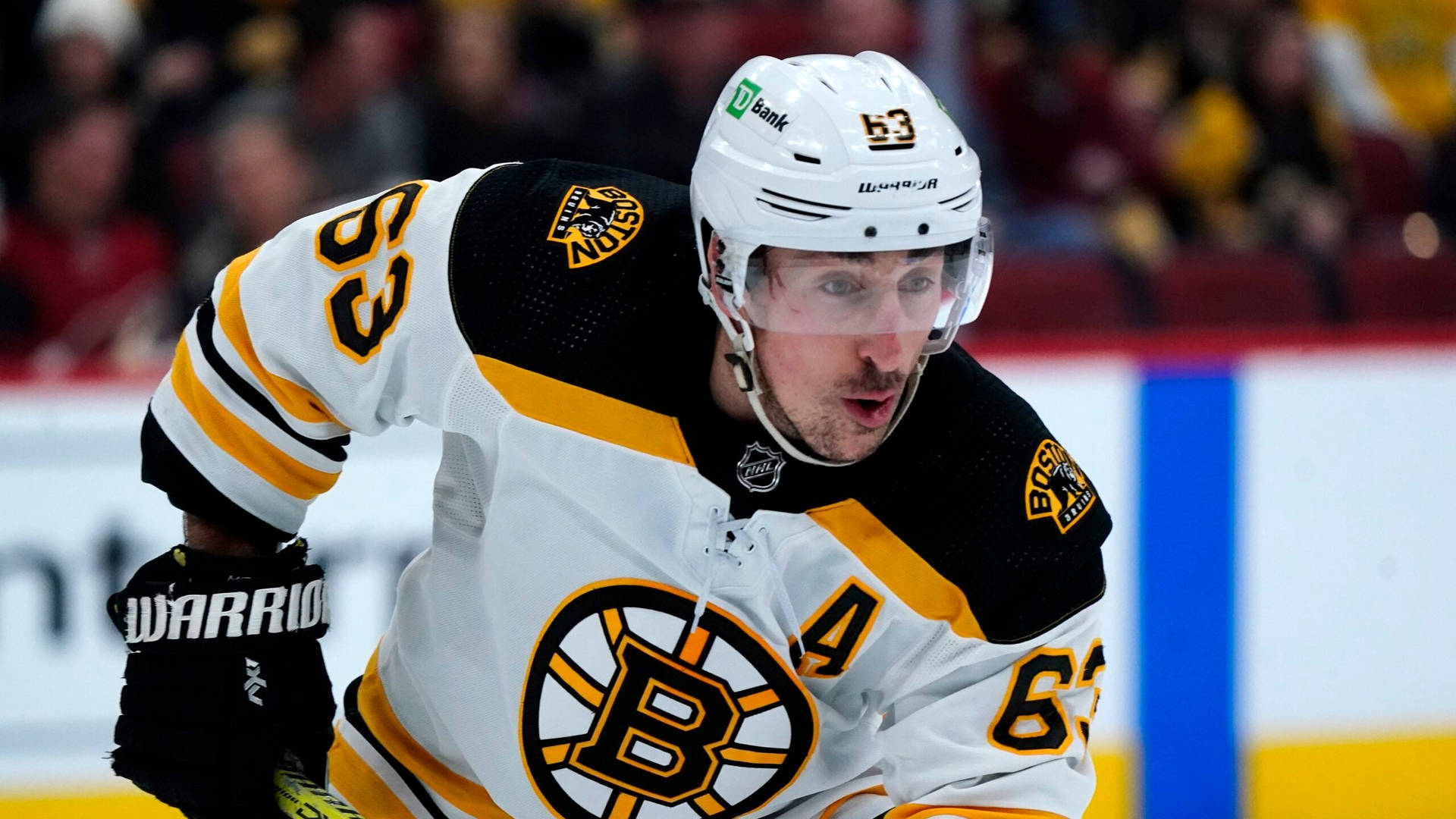 Brad Marchand Of The Boston Bruins In Action With White Uniform.