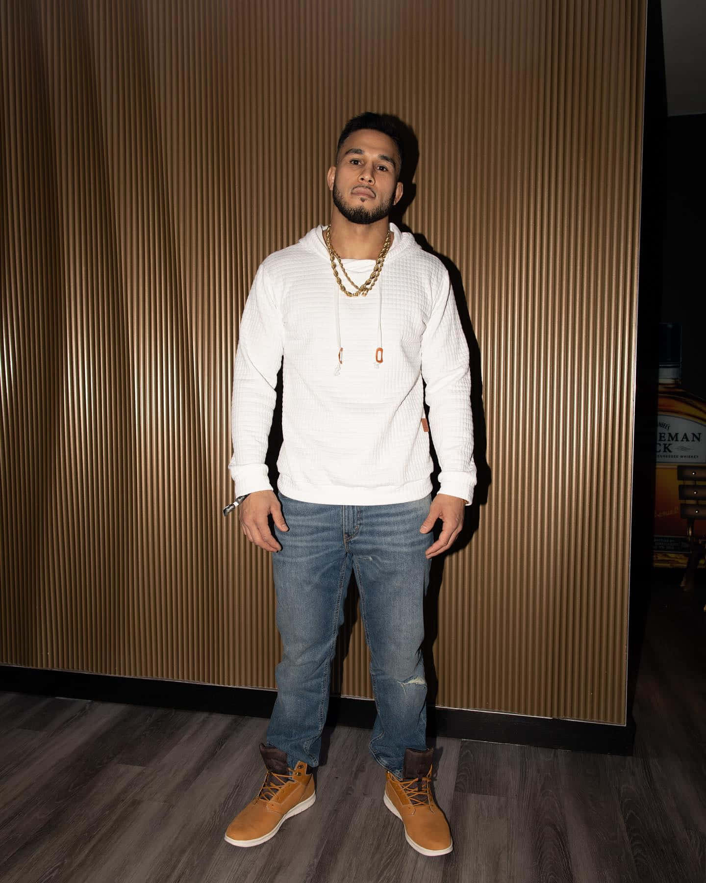 Brad Tavares In White Shirt With Gold Chain Background