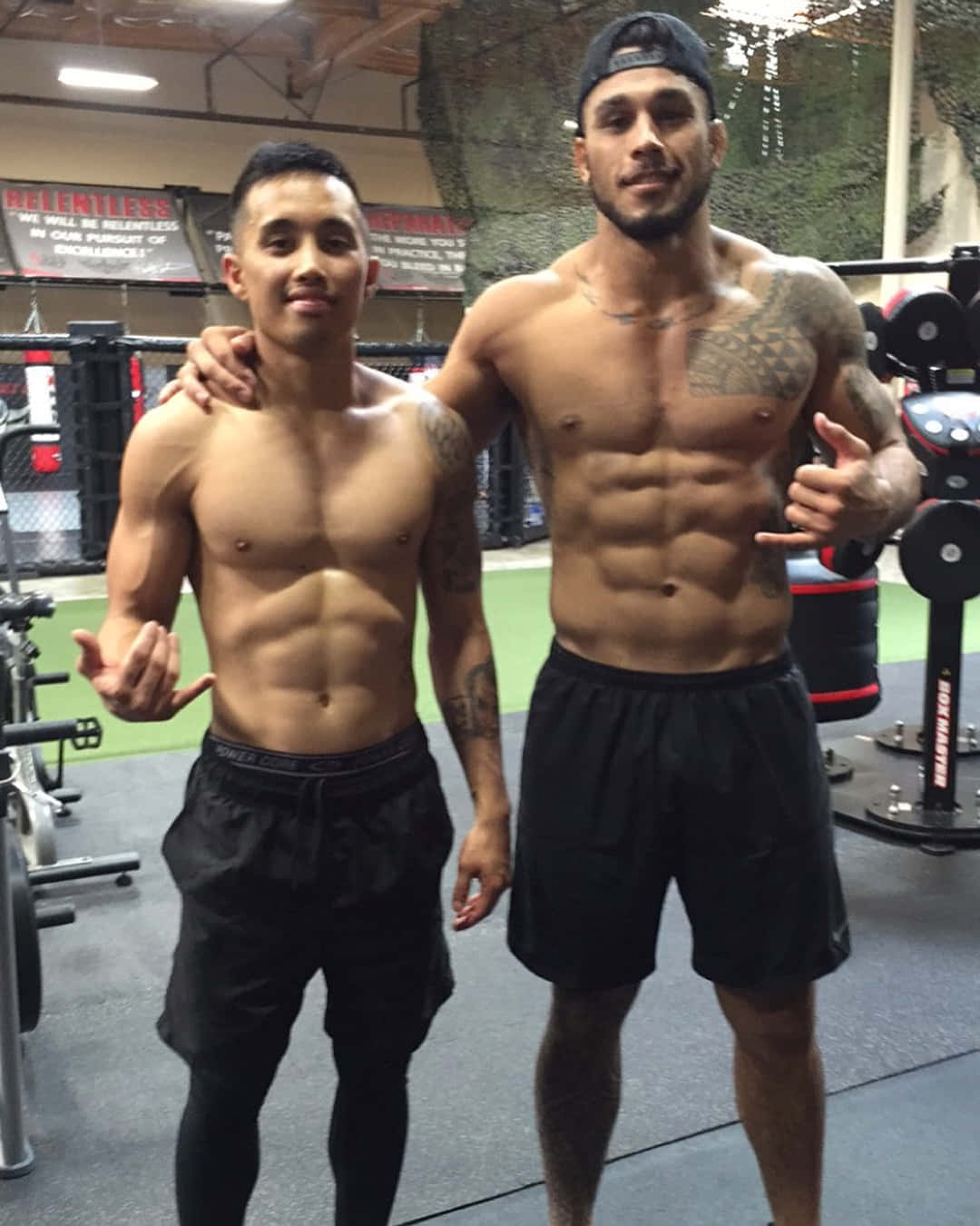 Brad Tavares Posing With Man At The Gym