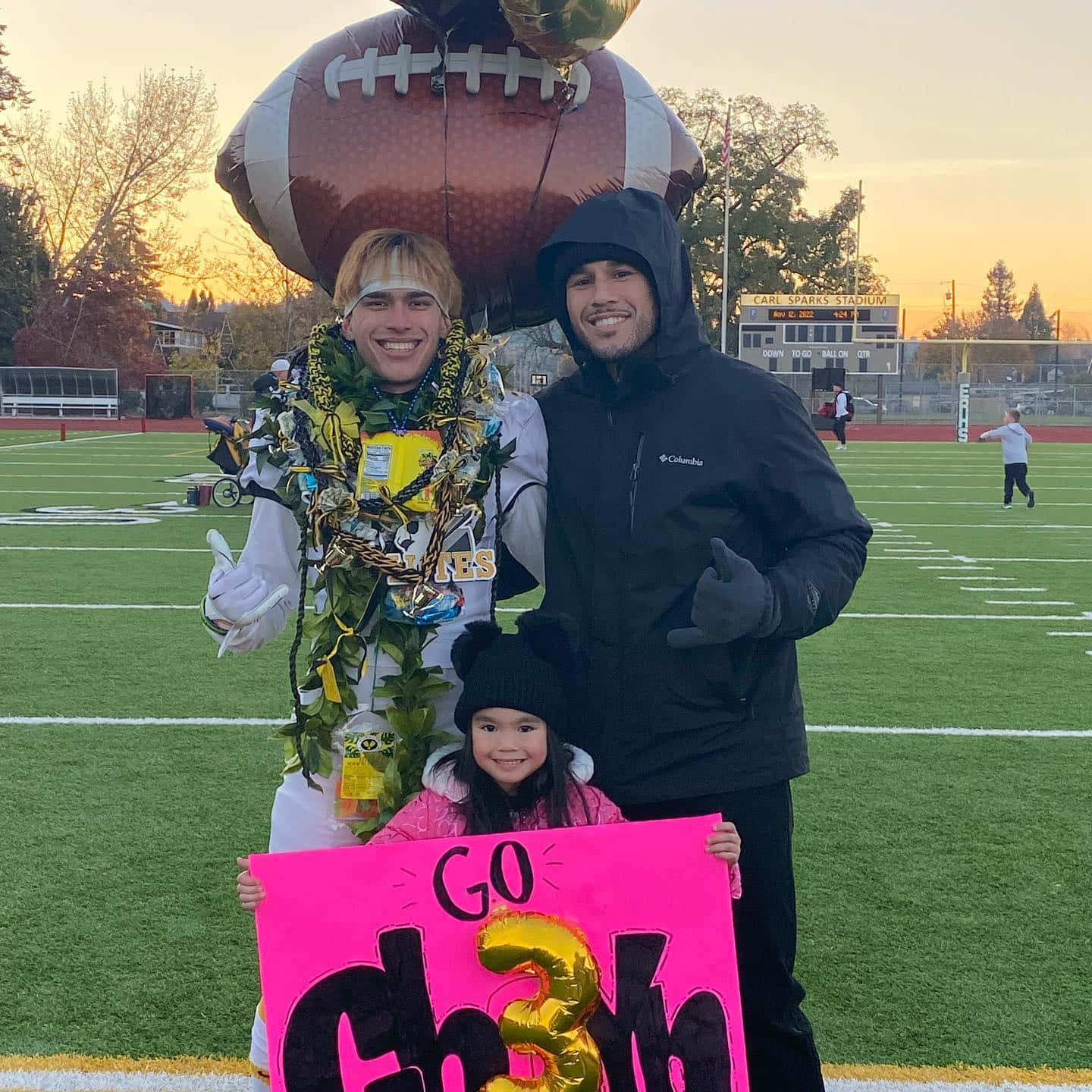 Brad Tavares With His Family At A Game Background