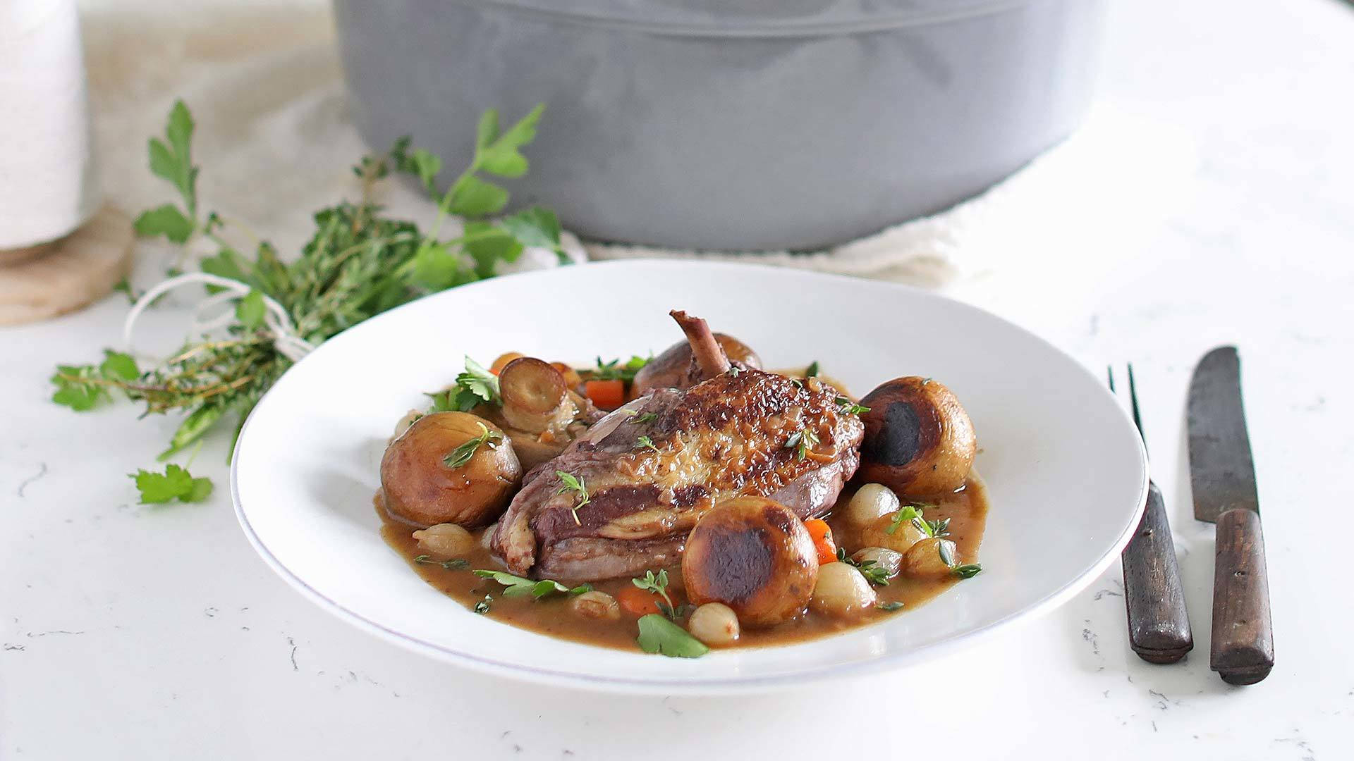 Braised Chicken Coq Au Vin On A White Plate