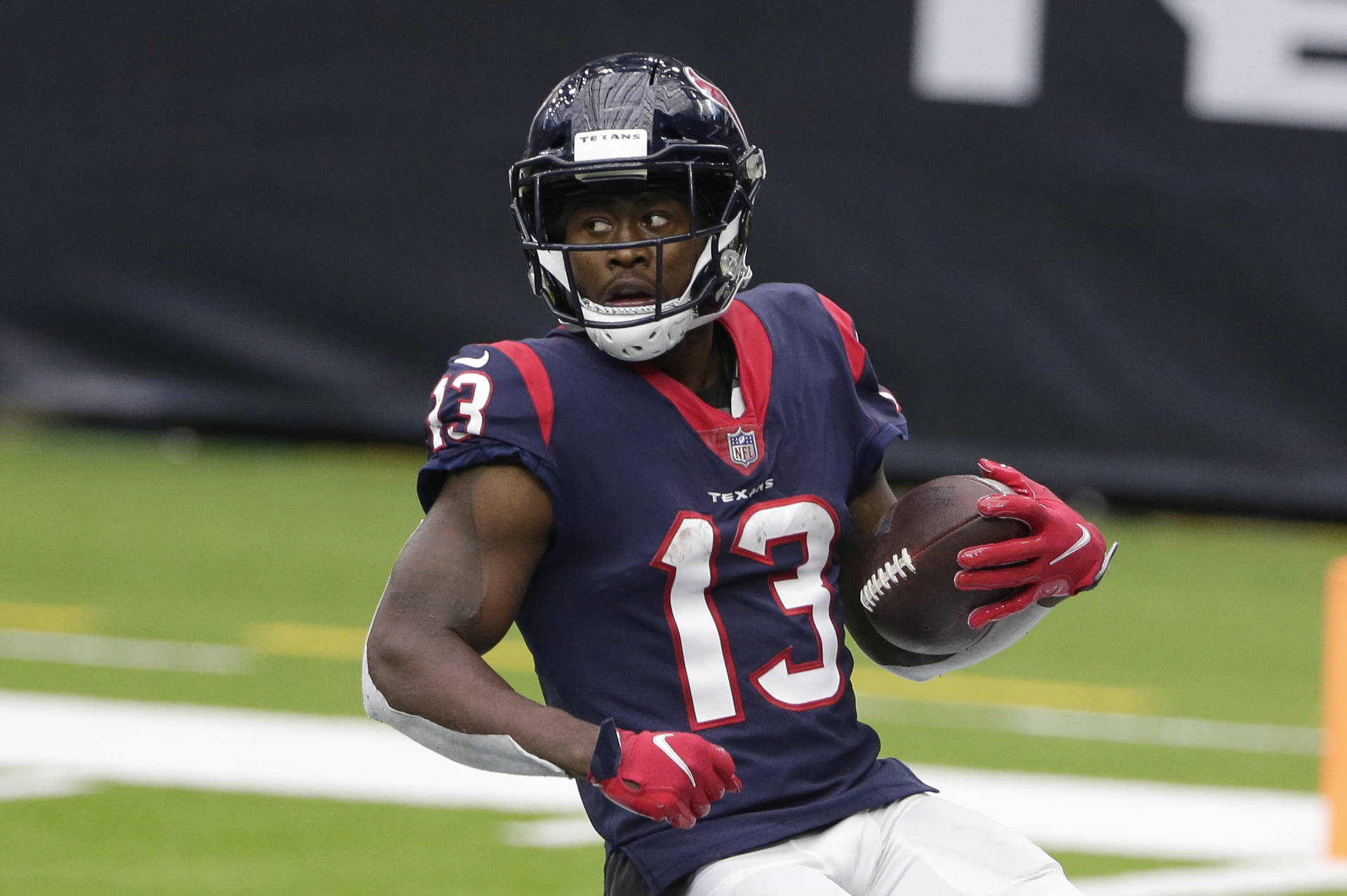 Brandin Cooks Holding A Ball Background