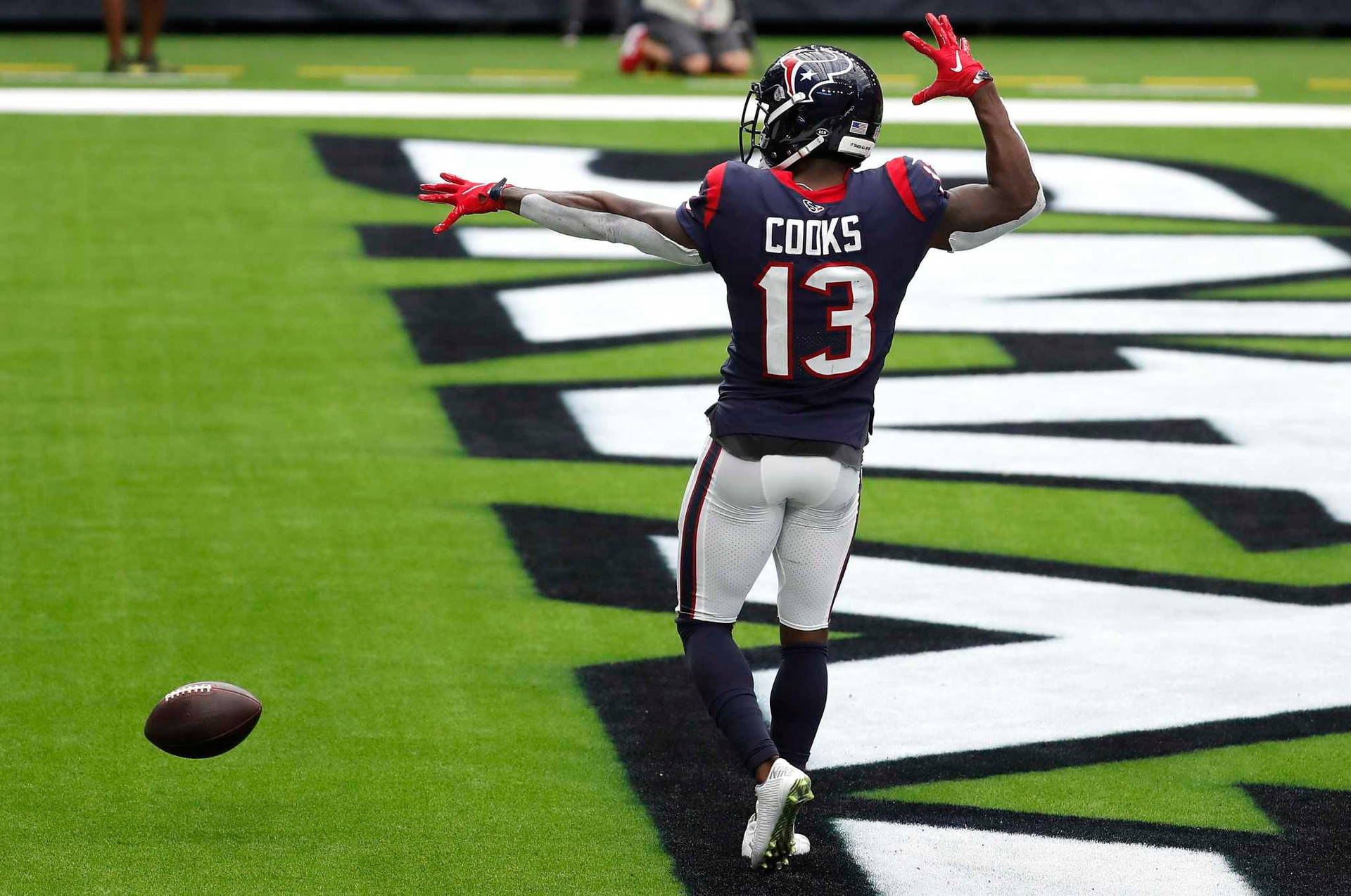 Brandin Cooks Near A Ball Background