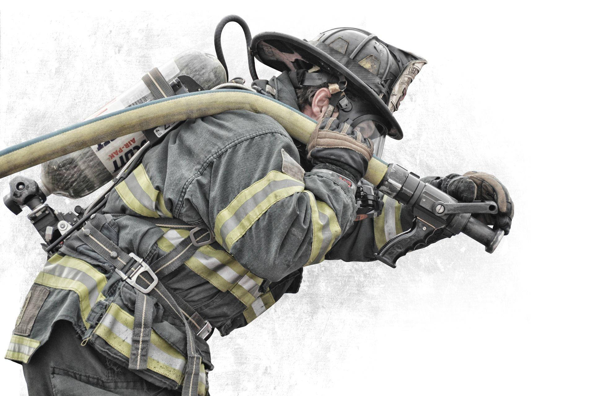 Brave Firefighter Battling The Flames Background