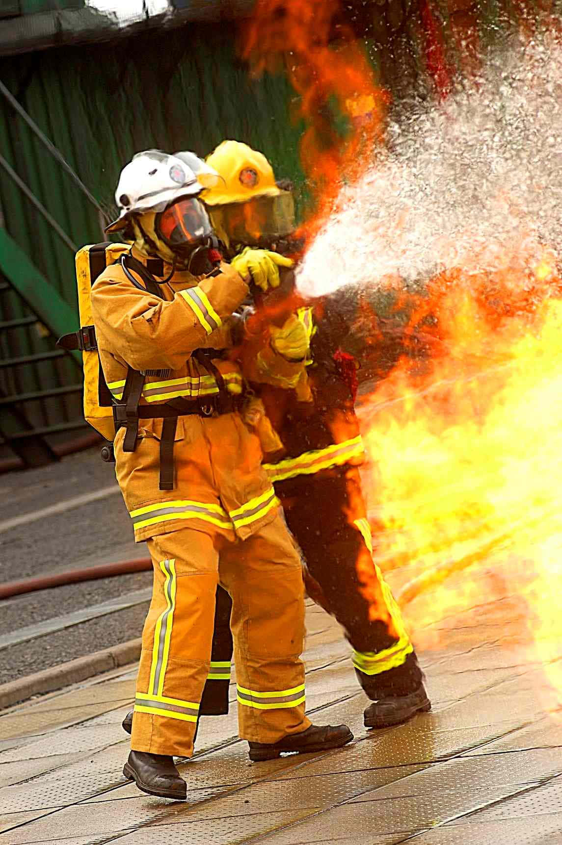 Brave Firefighter Communicating Via Phone Background