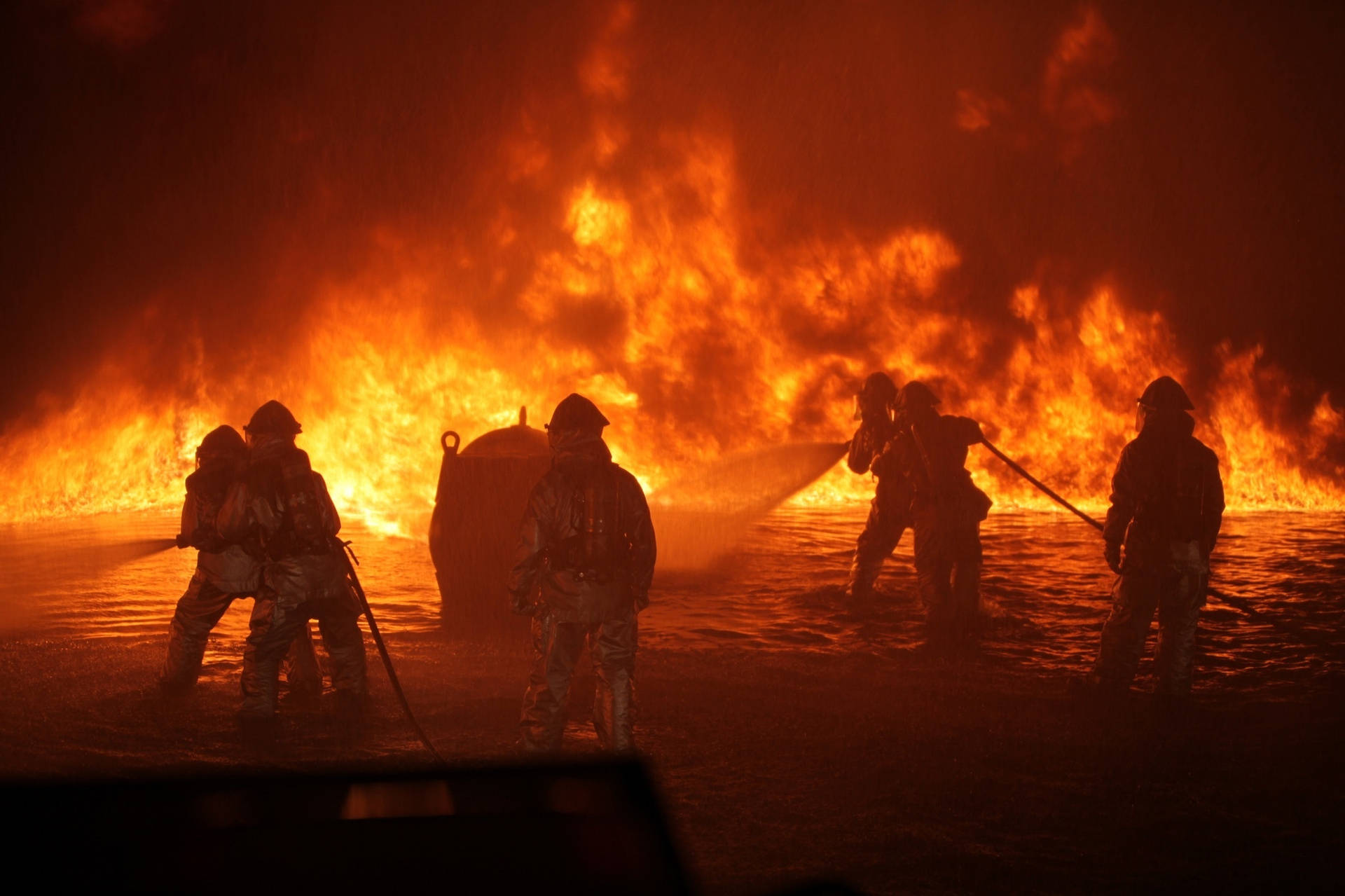 Brave Firefighters Battling Inferno Background