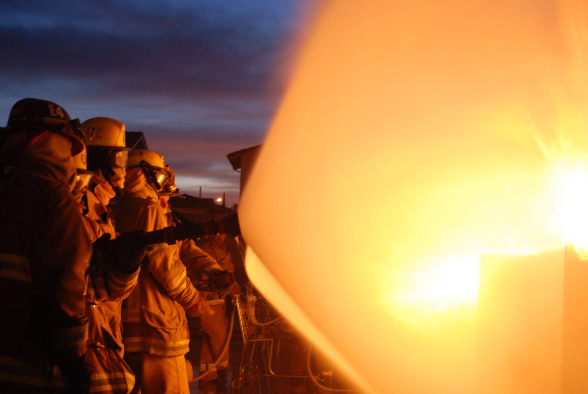 Brave Firefighters In Action Background