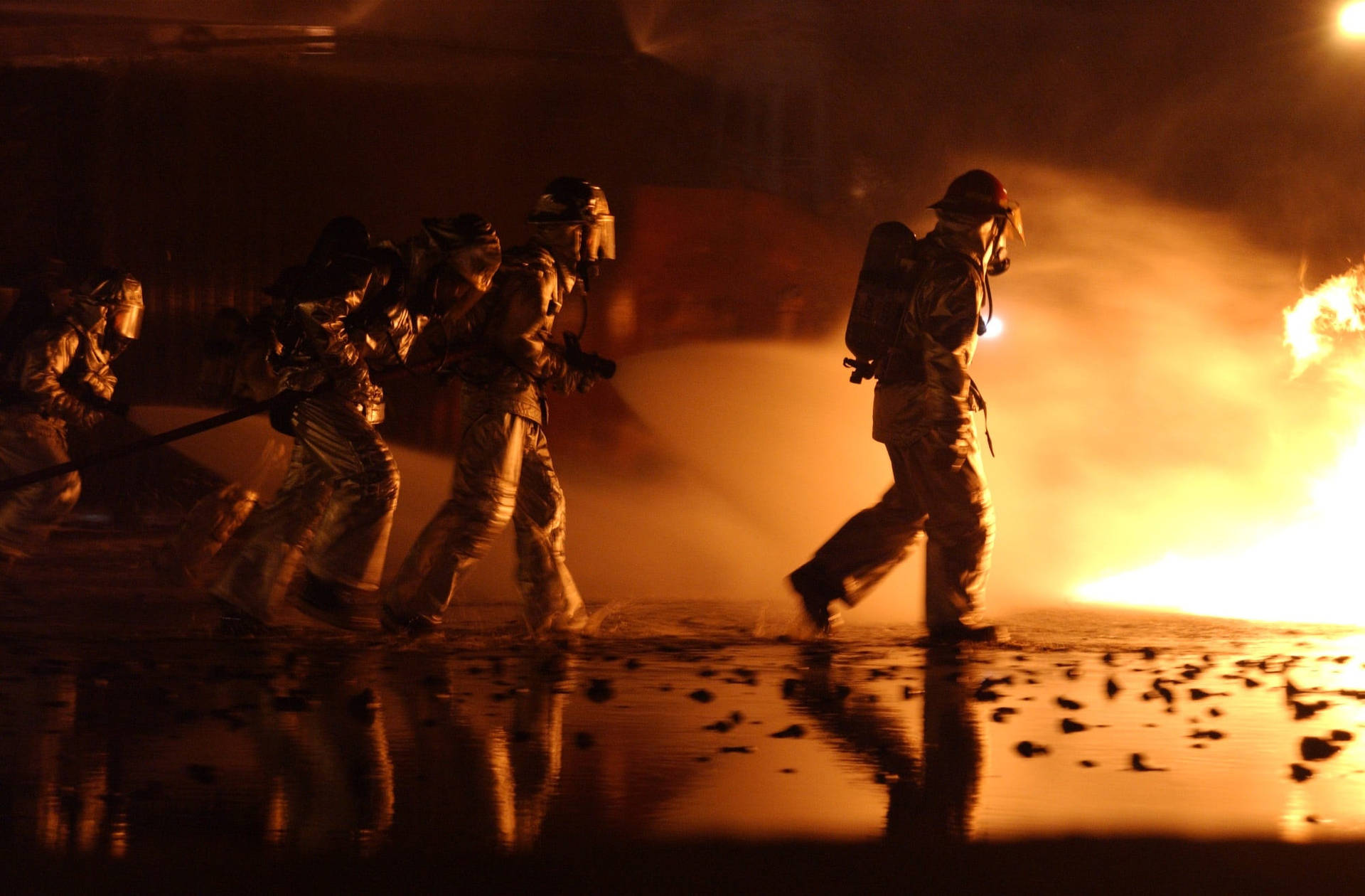 Brave Firefighters Marching Towards Danger Background