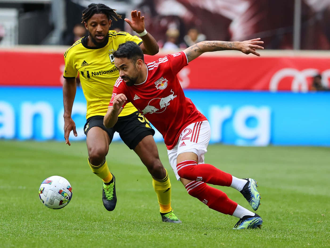 Brazilian Footballer Luquinhas Against A Columbus Crew Player Background