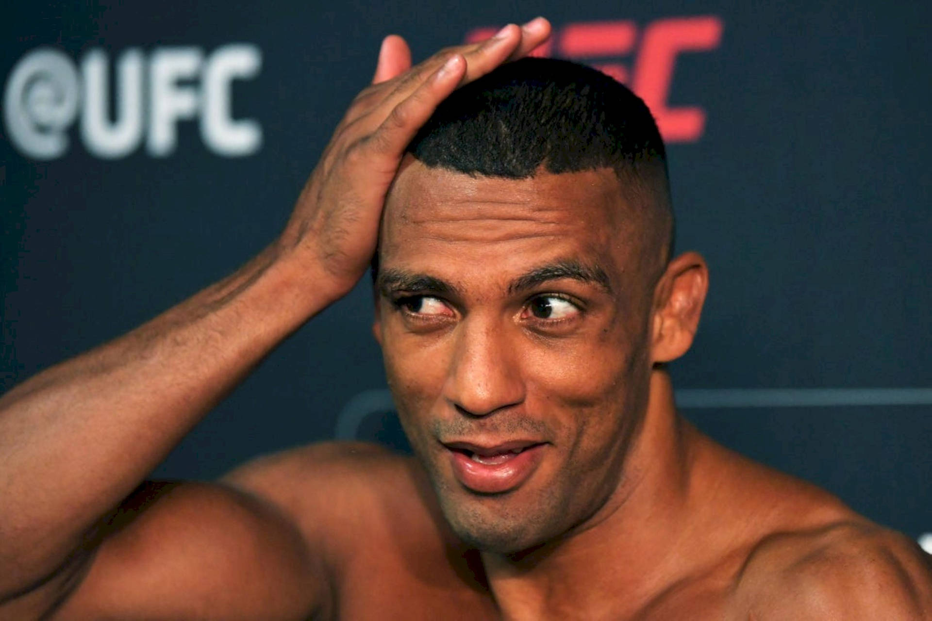 Brazilian Mma Fighter Edson Barboza Holding His Hair Background