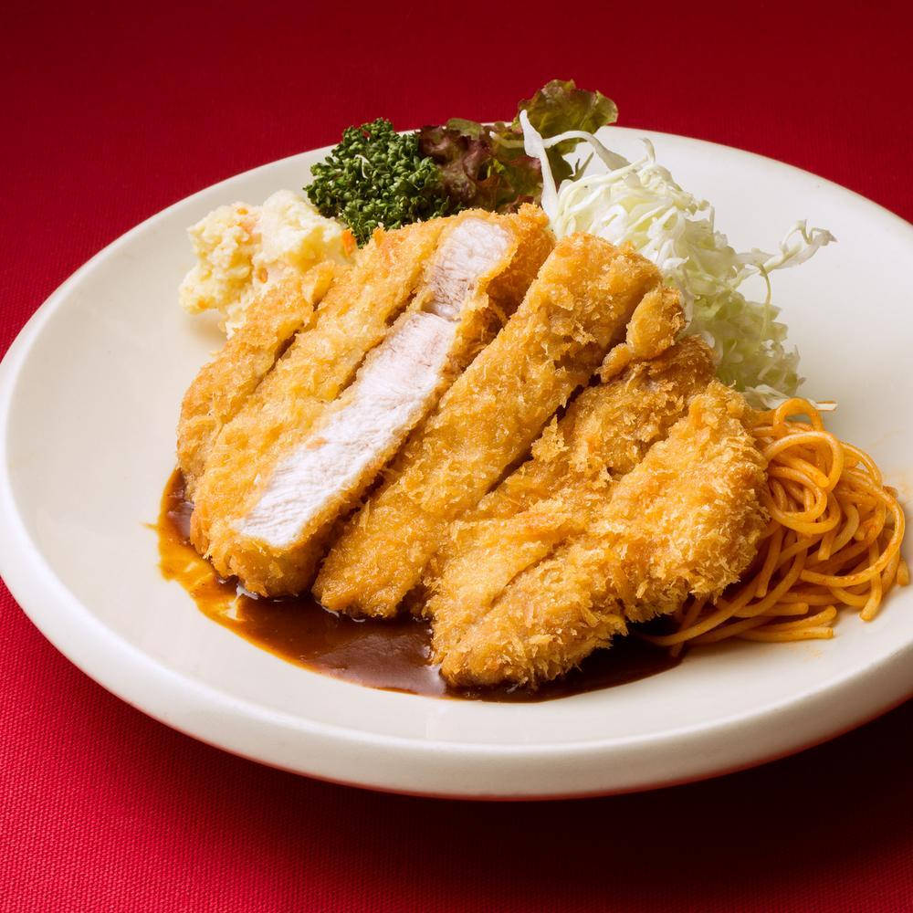 Breaded Tonkatsu With Pasta On A White Plate Background