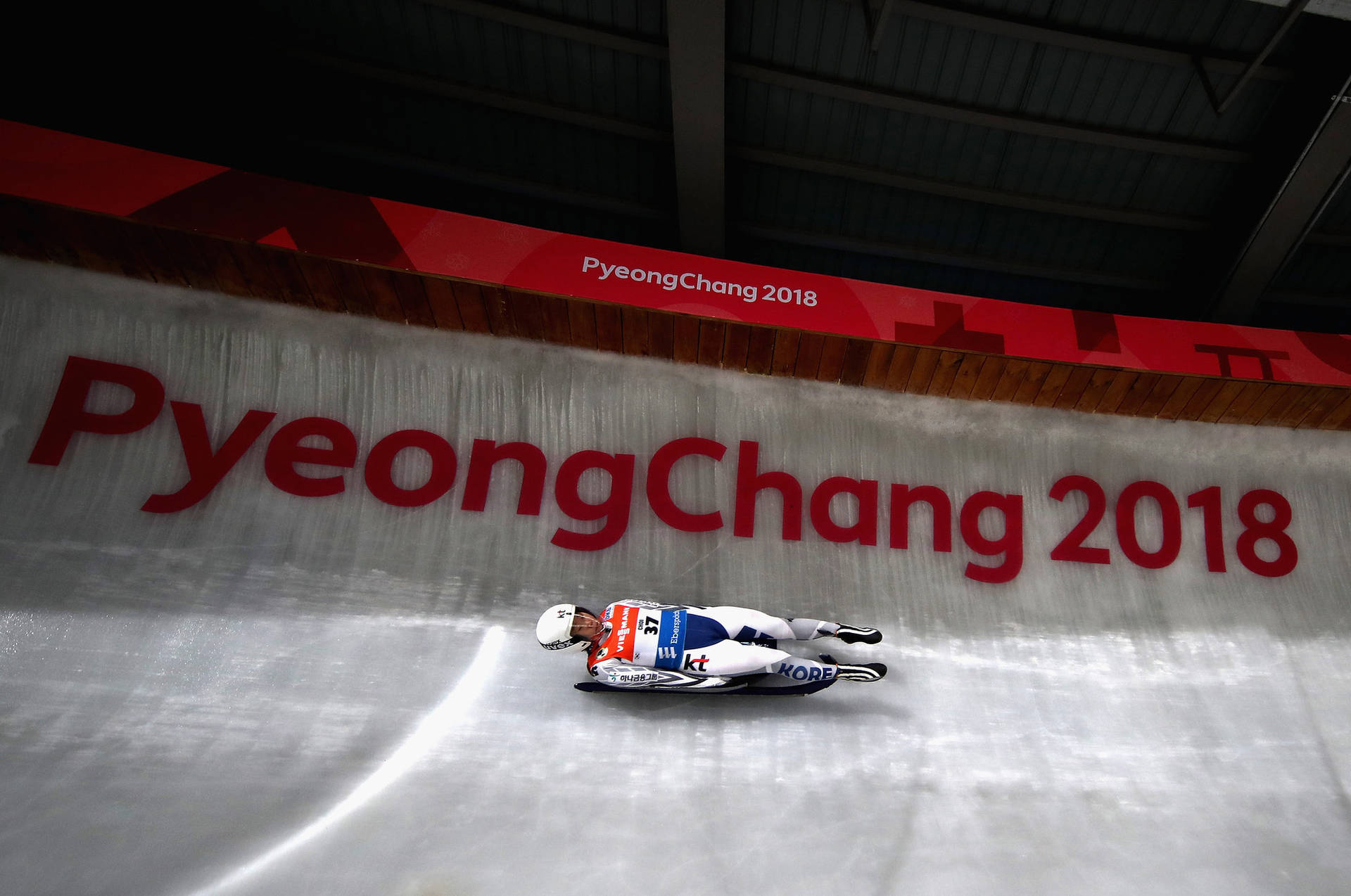 Breakneck Speed - A Luge Athlete In Action Background