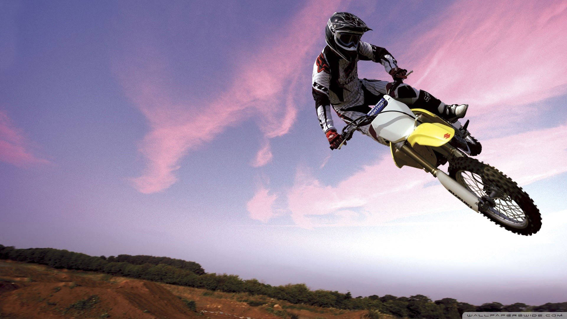 Breathtaking Mid-air Moment On A Dirt Bike Background