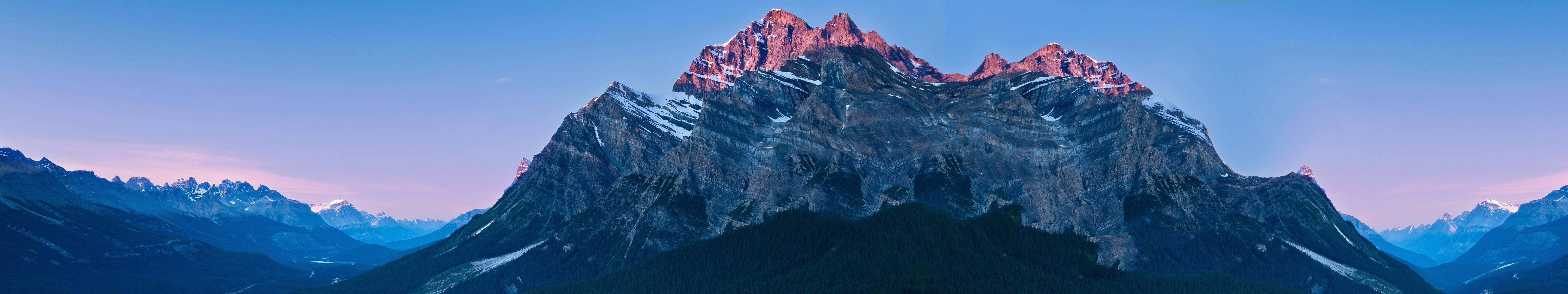 Breathtaking Mountain Range Three Screen Background