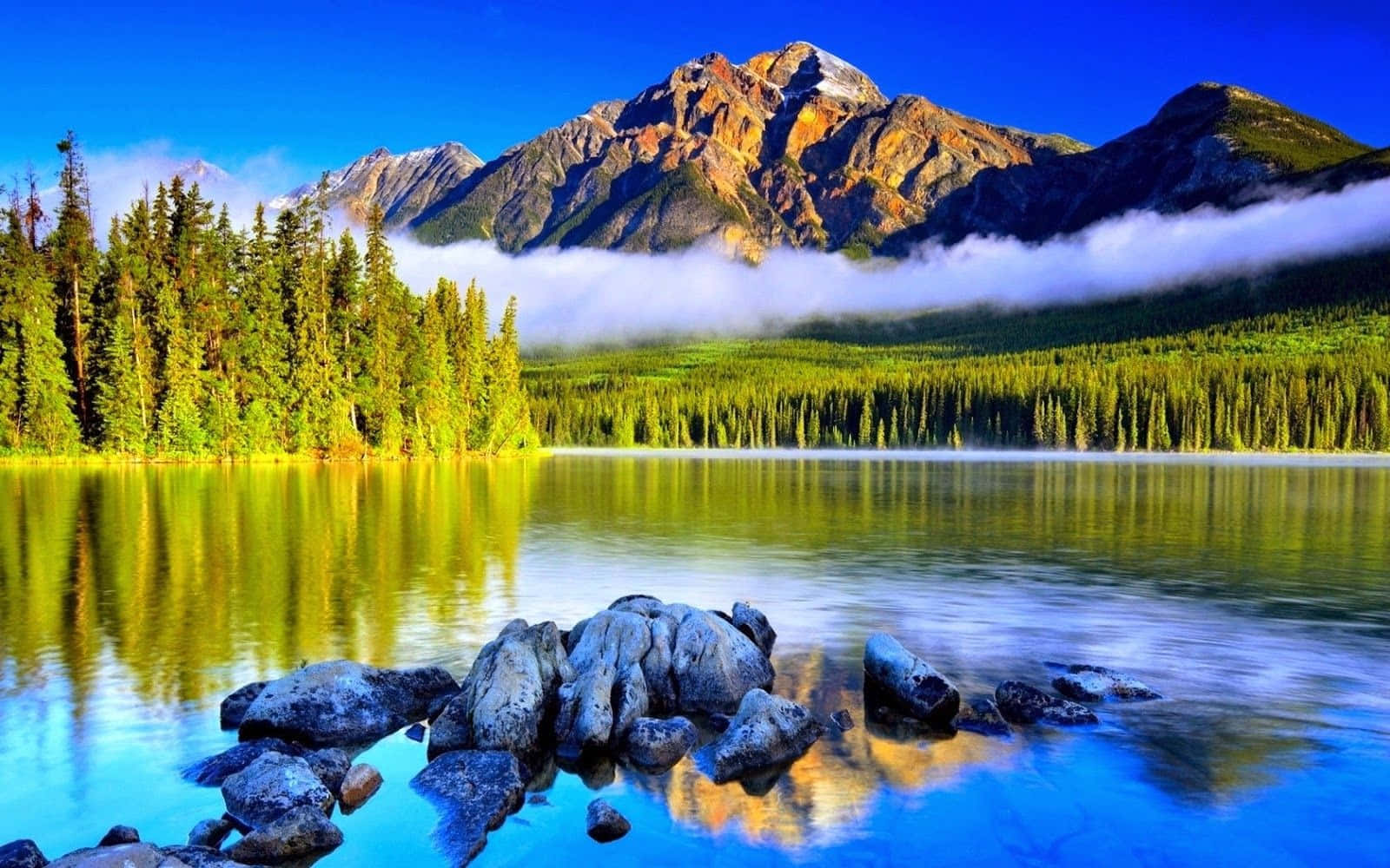 Breathtaking Scenery Of A Magnificent Waterfall And Lush Forest Background