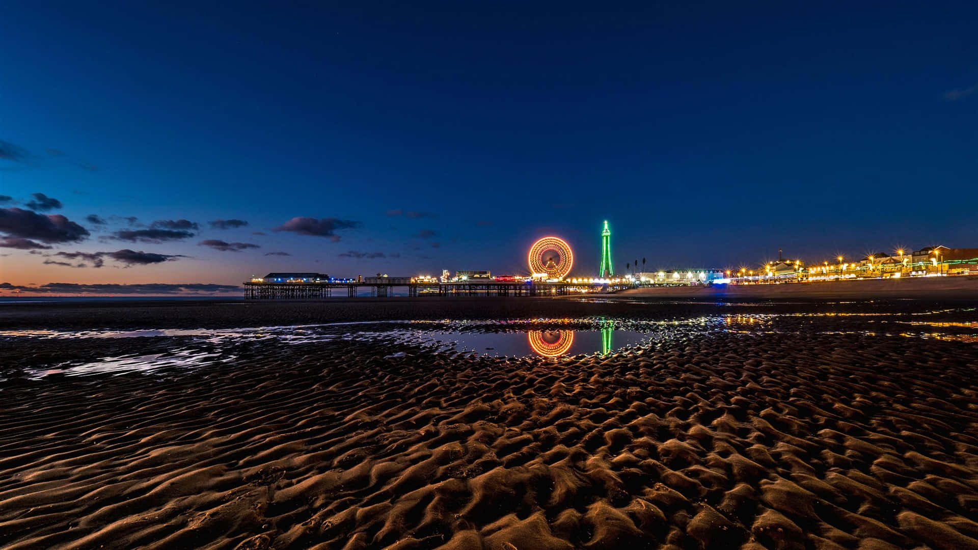 Breathtaking View Of Blackpool Tower Alongside Central Pier Big Wheel Background