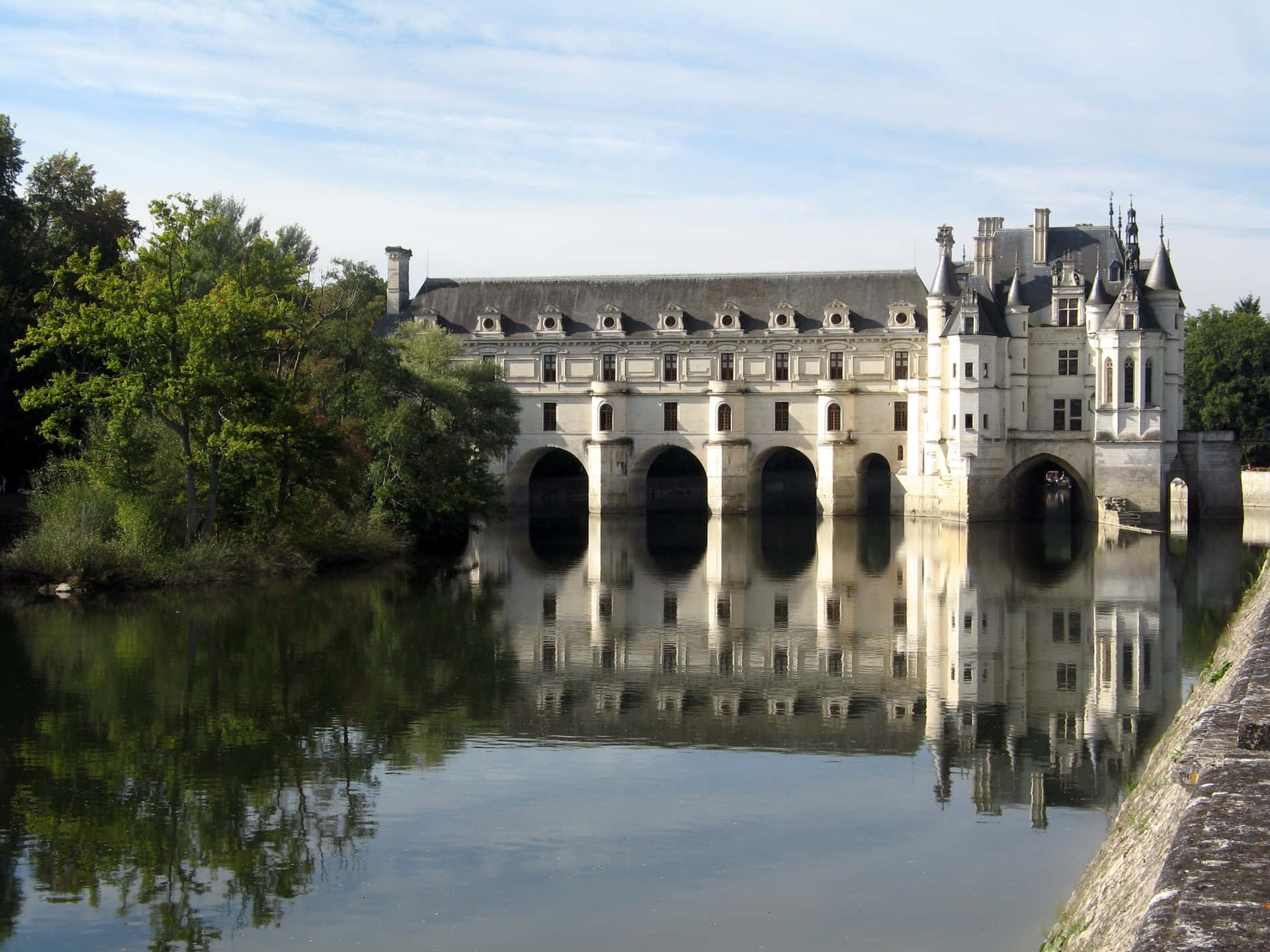 Breathtaking View Of Chenonceau Castle Amidst Riverside Vegetation