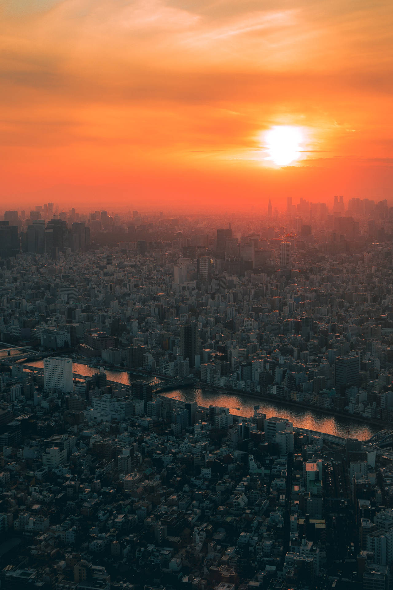Breathtaking View Of Japan's Cityscape At Sunset Background