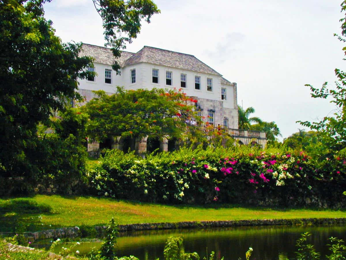 Breathtaking View Of The Historic Rose Hall Great House Amidst Lush Greenery. Background