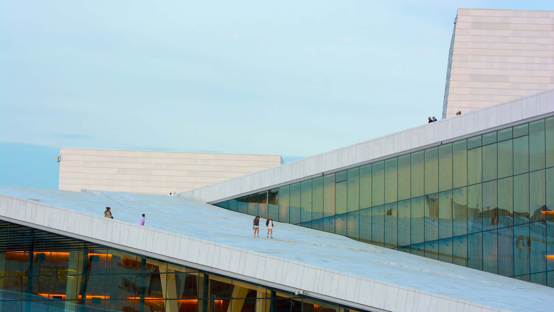 Breathtaking View Of The Oslo Opera House Bustling With People.