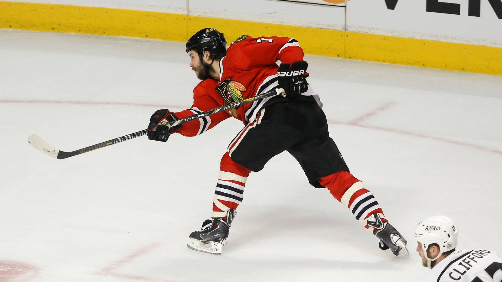 Brent Seabrook Skating On Ice Background