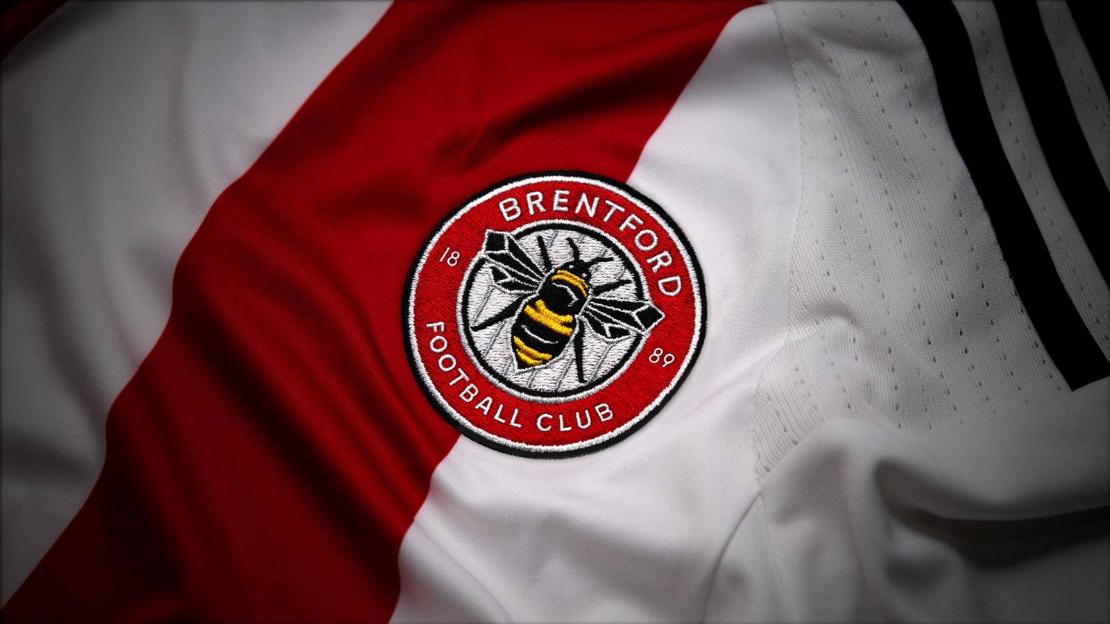 Brentford Fc Emblem Proudly Embroidered On A Football Jersey. Background