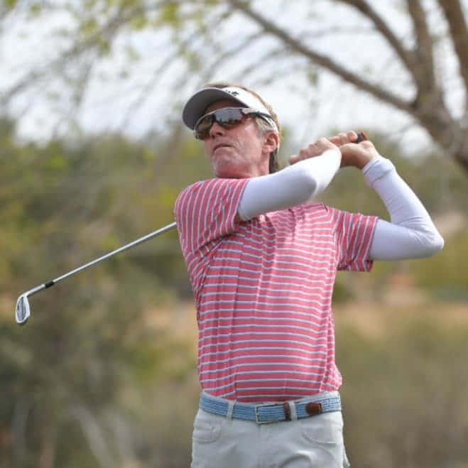 Brett Quigley In Mid-swing During A Golf Tournament Background
