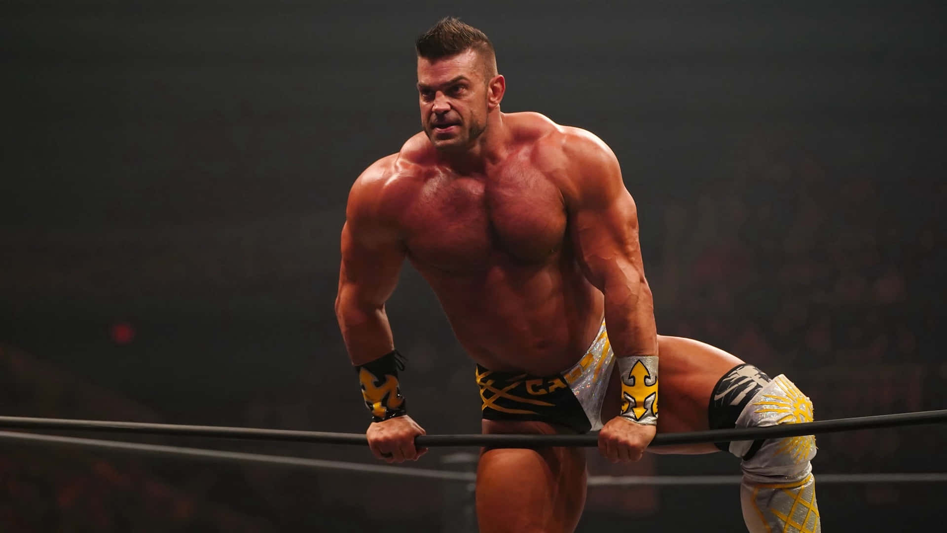 Brian Cage Exhibiting Power In The Wrestling Ring Background