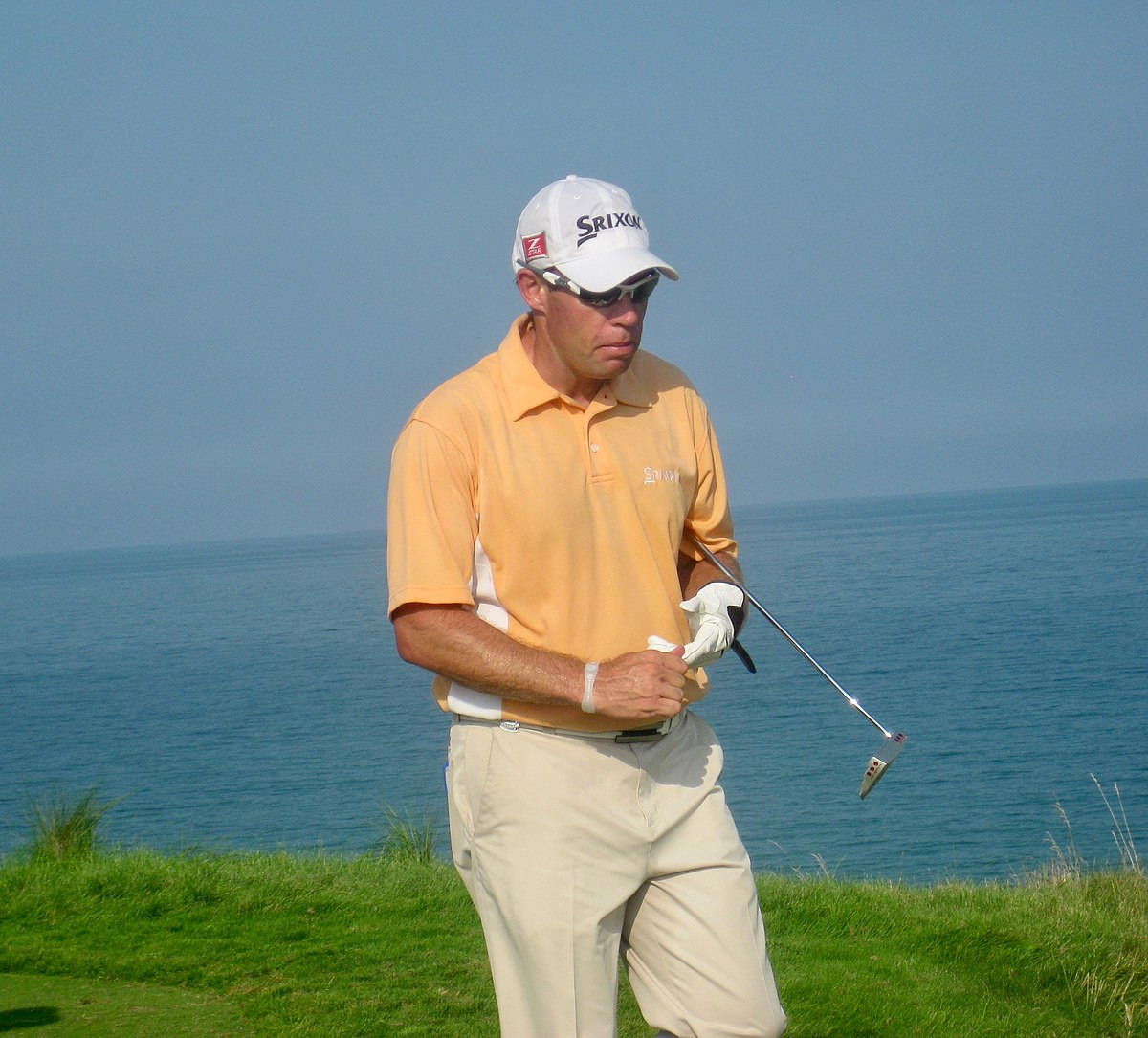 Brian Davis Playing Golf Beside A Lake Background