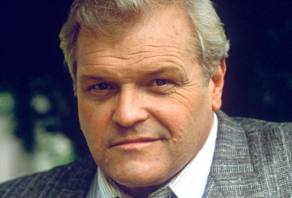 Brian Dennehy In Gray Suit Smiling Background