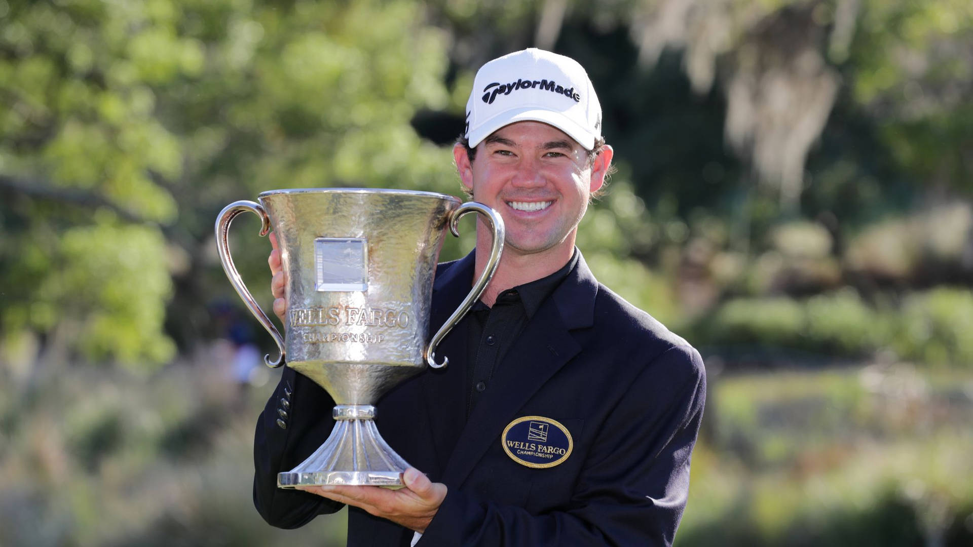 Brian Harman Grinning With Trophy Background