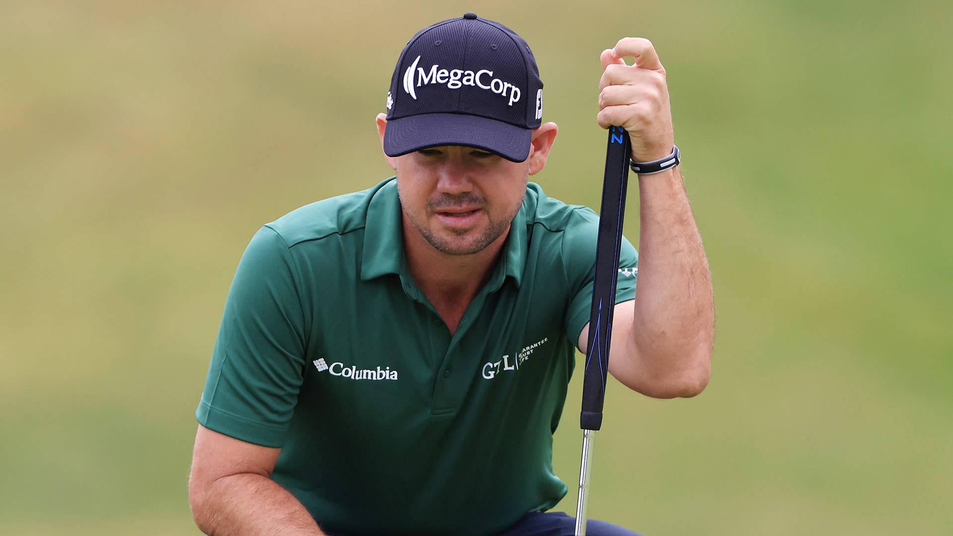 Brian Harman Leaning On Golf Club Background