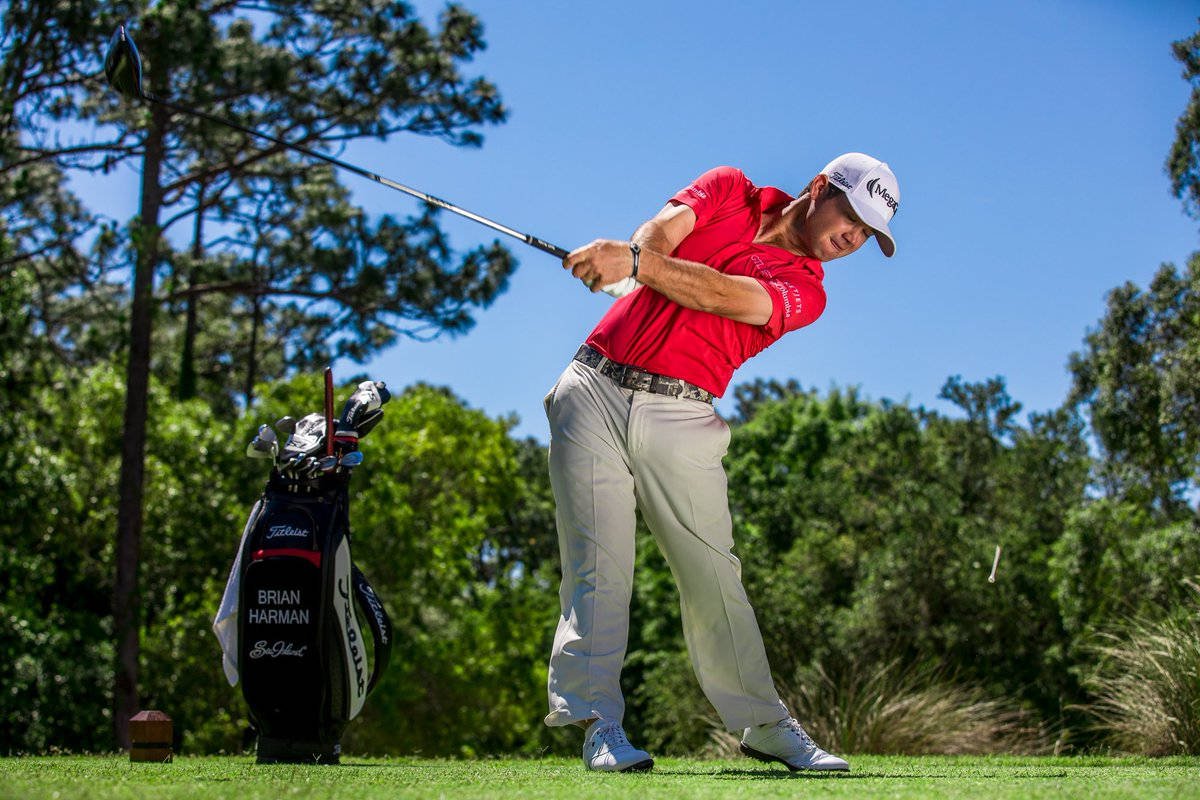 Brian Harman Swinging His Golf Club On A Bright, Sunny Day Background